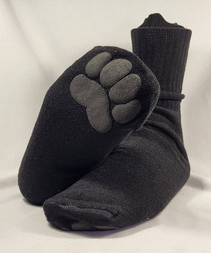 Black toe-separated socks with paw print design on a light gray background