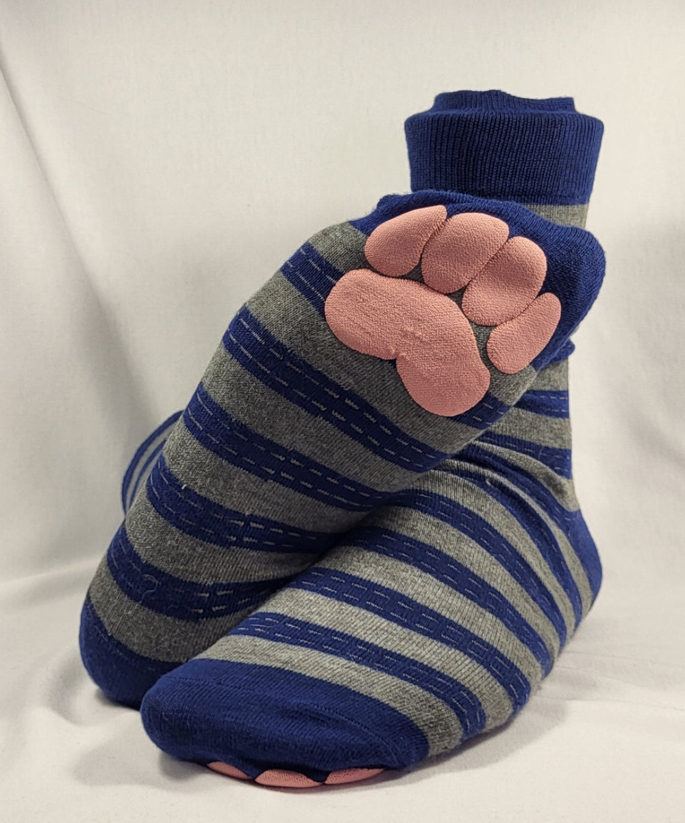 Striped socks with pink paw prints on a white background